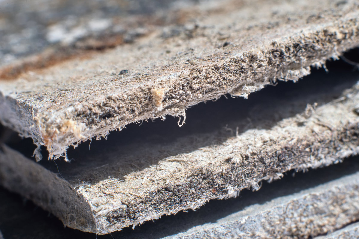 Detailed photography of building material with asbestos fibres. Health harmful and hazards effects. Prolonged inhalation of microscopical fibers causes fatal illnesses including lung cancer.