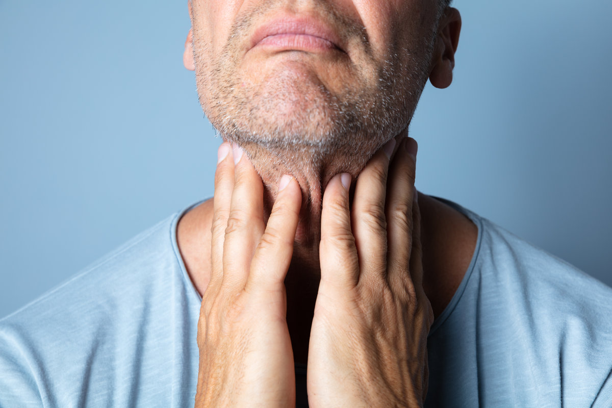 Close-up Of A Man's Hand Touching Her Sore Throat