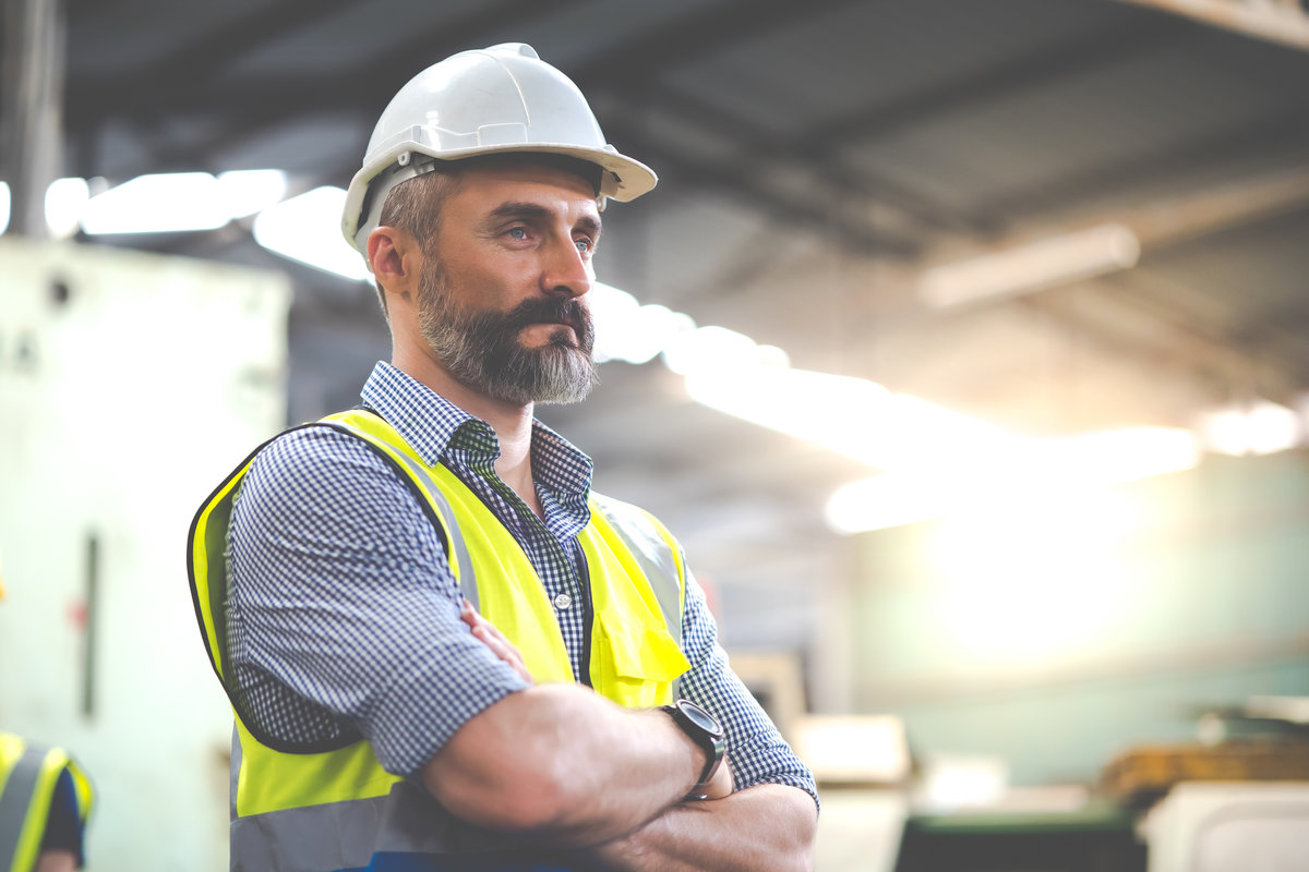 Portrait Caucasian professional Engineer factory. Engineering worker in safety hardhat at factory industrial facilities. Heavy Industry Manufacturing Factory